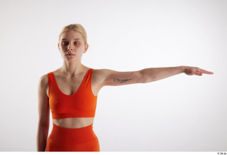Unaisa  1 arm dressed flexing front view orange sports…
